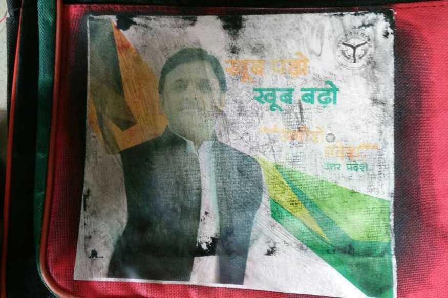 Why is Gujarat govt distributing school bags with Akhilesh Yadav's photo on it?