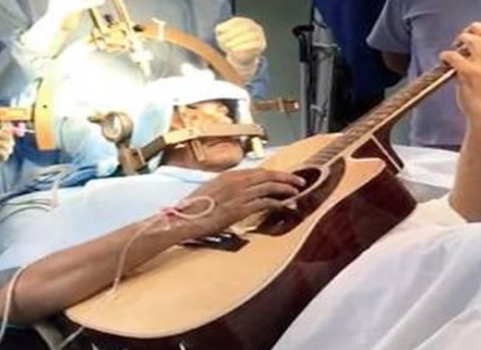 Man plays guitar while surgeons operate his brain
