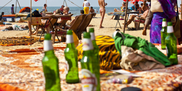 GOA, INDIA - FEBRUARY 01: Beach life - Empty beer bottles and tourists who take a sunbath at the sandy beach of Anjuna on February 1, 2012 in Goa, India (Photo by EyesWideOpen/Getty Images)