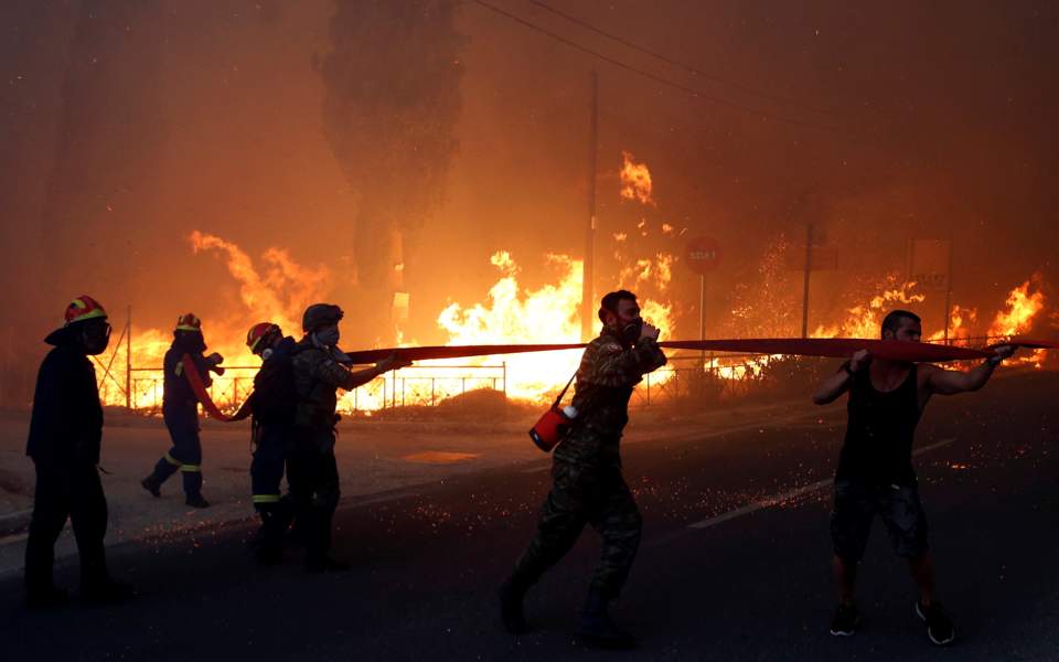 20 dead as forest fires rage across Greece