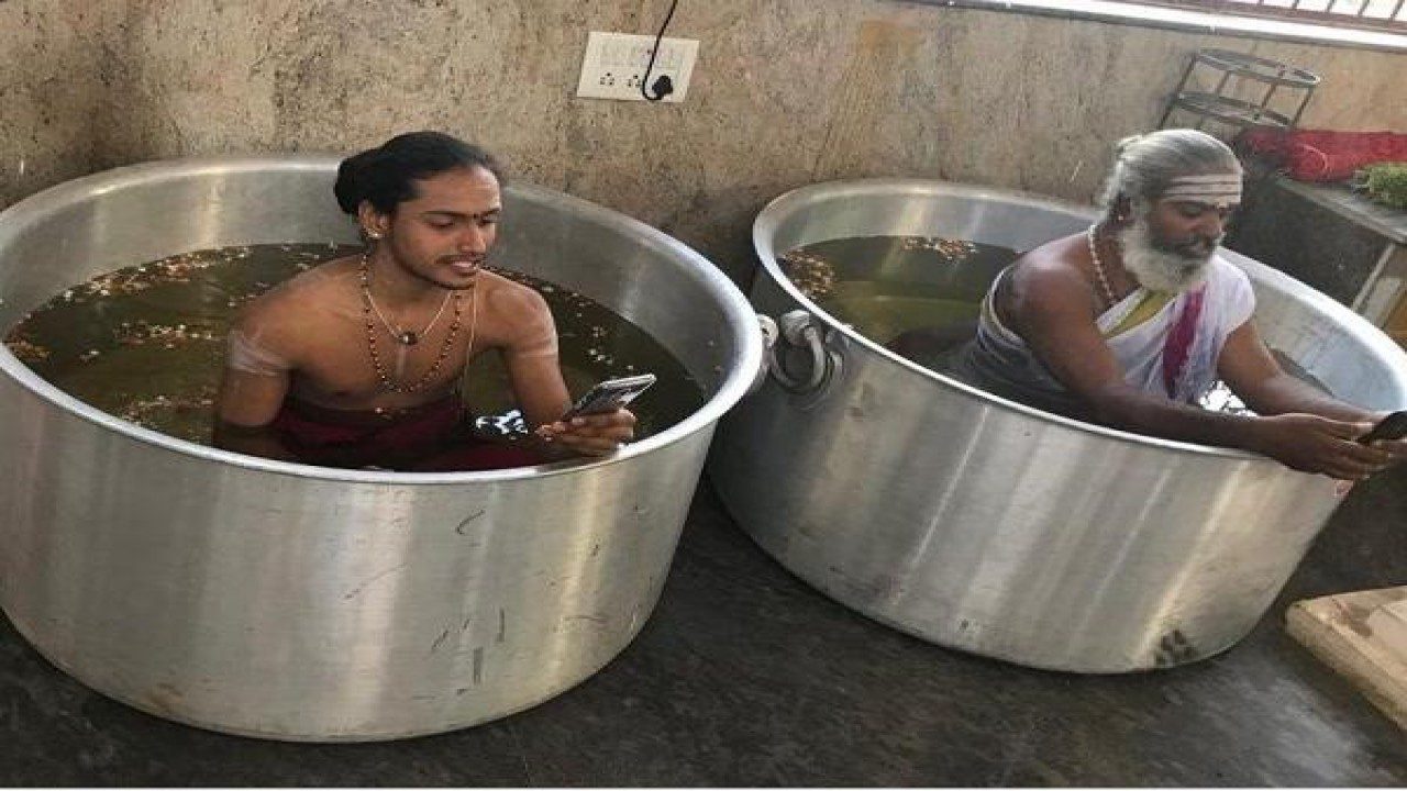 Karnataka: This temple’s priests sit in water-filled vessels, use mobile phones while performing puja to please rain gods