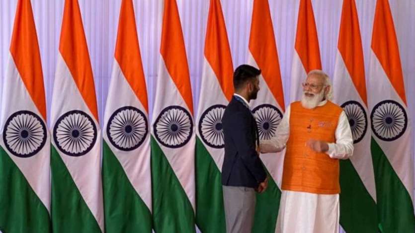 PM Modi speaks with India hockey men's team captain Manpreet Singh.